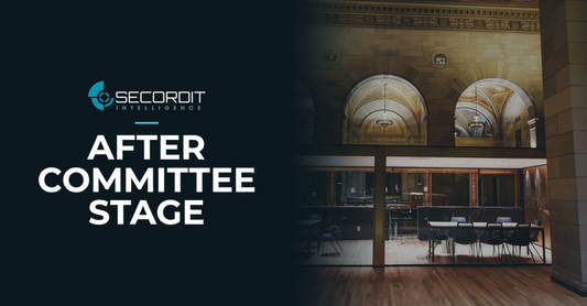 Secordit Intelligence logo and the headline “AFTER COMMITTEE STAGE” on a dark panel fading into a photo of an empty conference room behind glass.