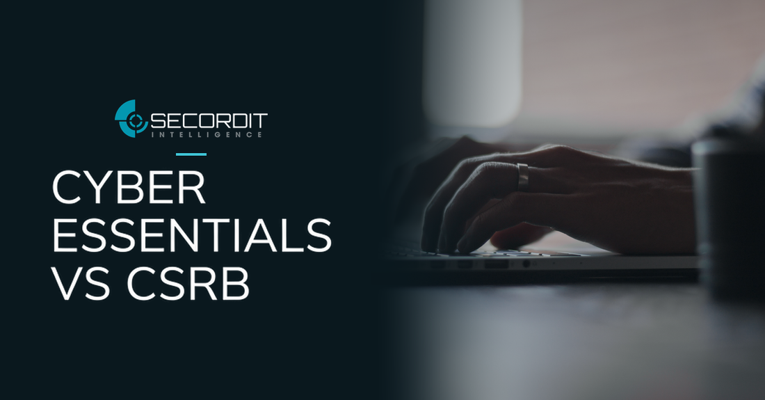 Secordit Intelligence logo and the headline “CYBER ESSENTIALS VS CSRB” on a dark panel fading into a photo of hands typing on a laptop.